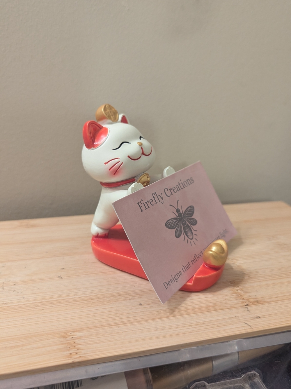 White & red lucky cat business card and phone holder